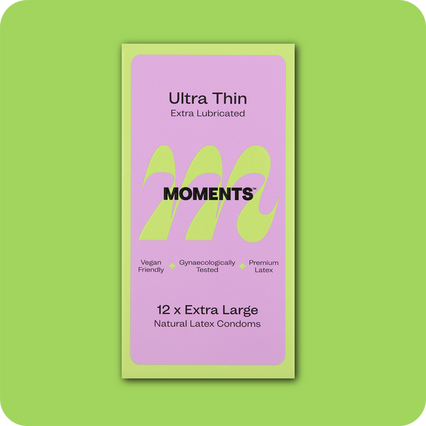Moments Ultra Thin Extra Large condom box against a green backdrop
