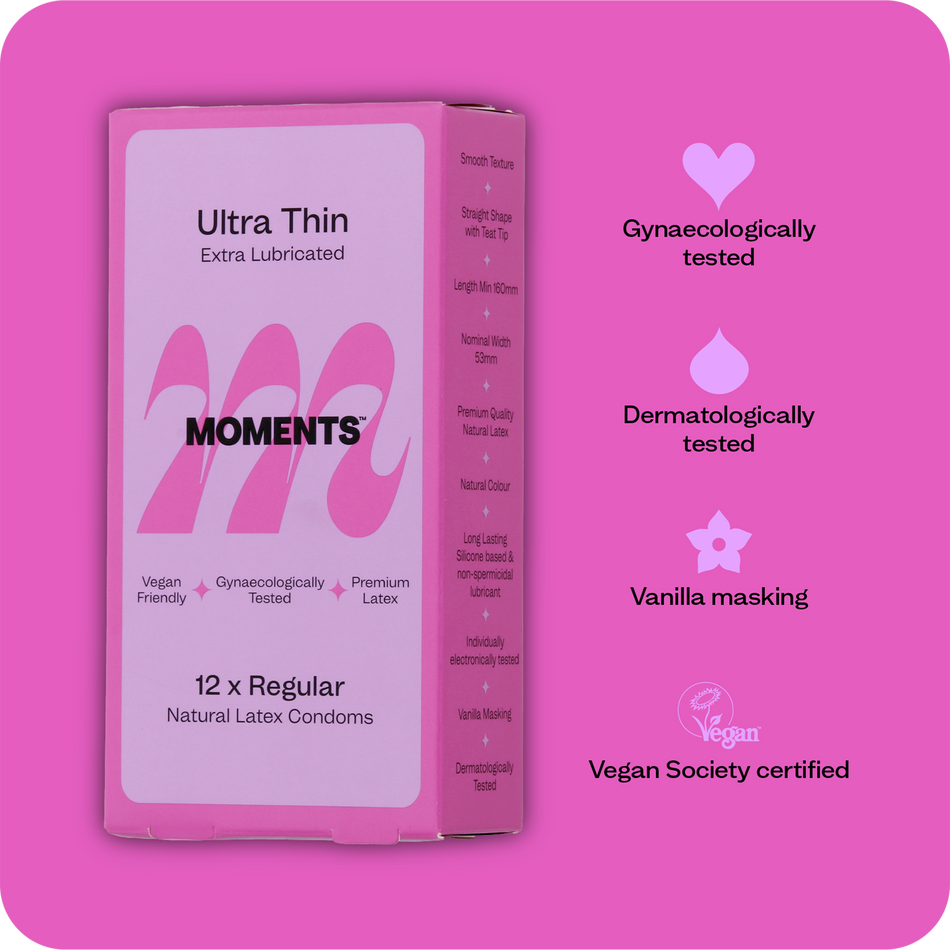 A hand presenting the Moments Ultra Thin Regular condom box with visible branding