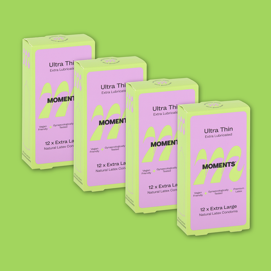 Moments Ultra Thin Extra Large condom box against a green backdrop